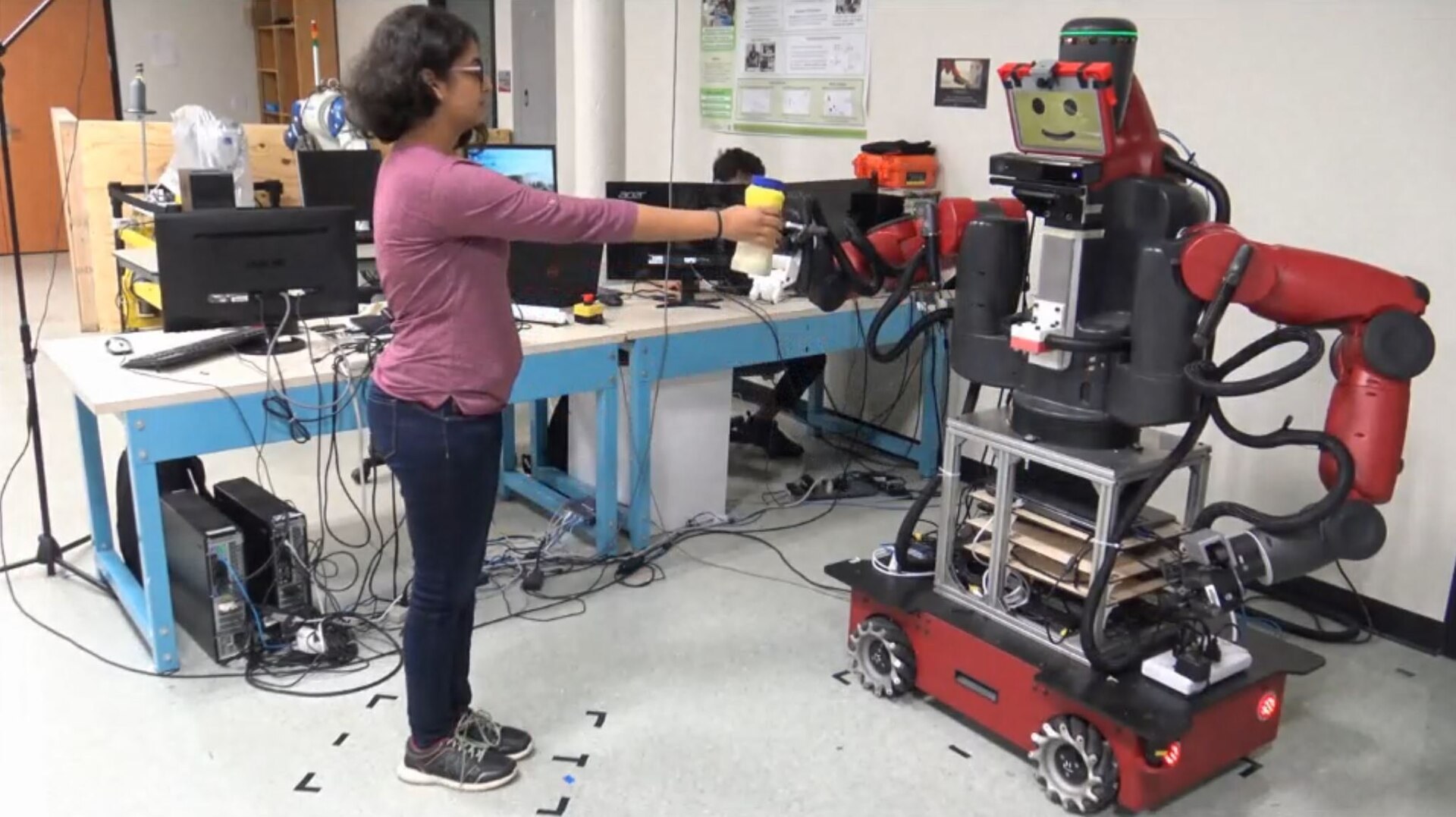 A robot assistant handing a cup to a person