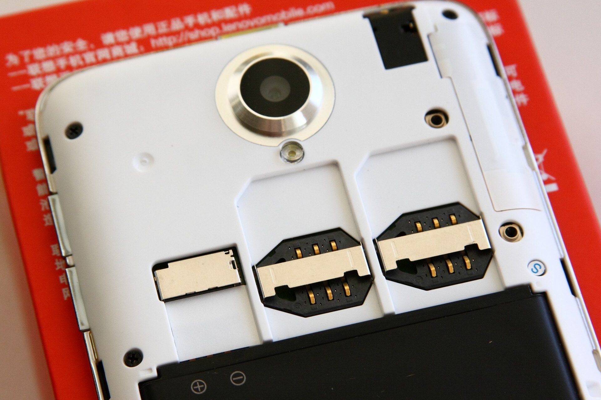 A SIM card being inserted into a smartphone